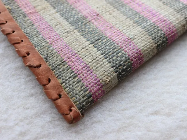 pink, green, and cream striped raffia woven clutch with leather trim