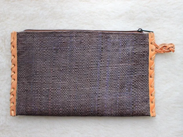 solid indigo raffia woven clutch with leather trim