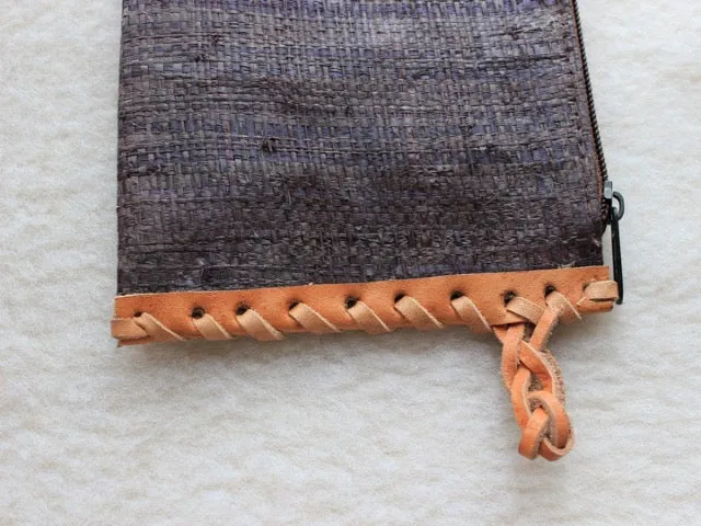 solid indigo raffia woven clutch with leather trim